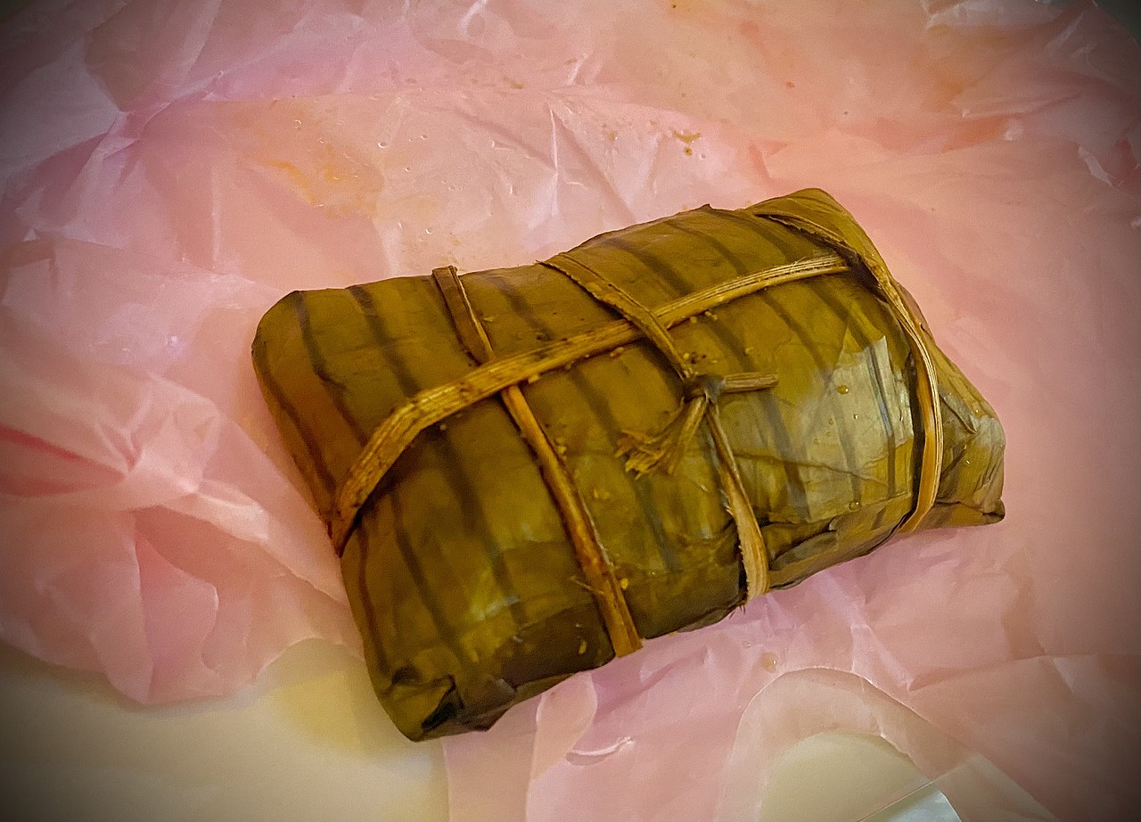 Traditional tamale preparation involves spreading masa on corn husks—a skill passed down through families and requiring practice to master.